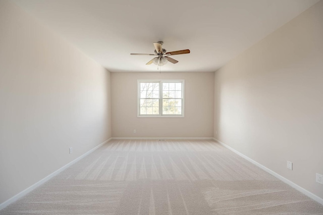 empty room featuring ceiling fan and light colored carpet