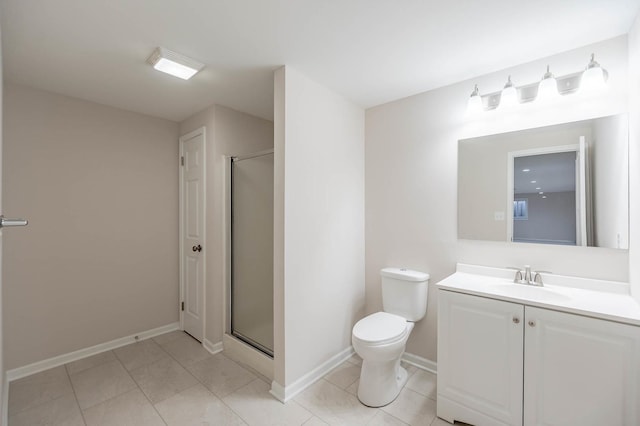 bathroom with a shower with door, vanity, tile patterned floors, and toilet