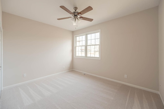 empty room featuring ceiling fan and light colored carpet