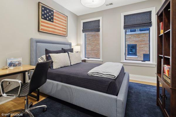 bedroom with dark wood-type flooring, visible vents, and baseboards