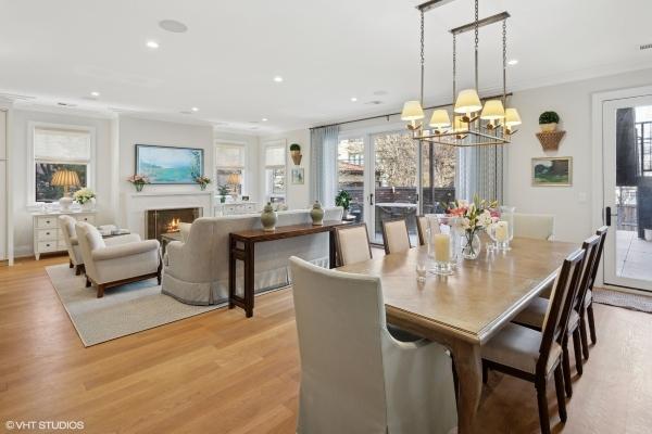 dining room featuring a notable chandelier, light wood finished floors, recessed lighting, ornamental molding, and a lit fireplace