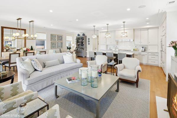 living area with light wood-style floors, recessed lighting, visible vents, and ornamental molding