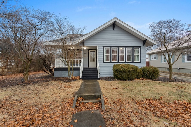 bungalow-style house with covered porch and a front lawn