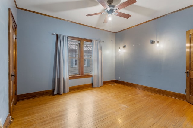 spare room with light wood-style floors, baseboards, and ornamental molding