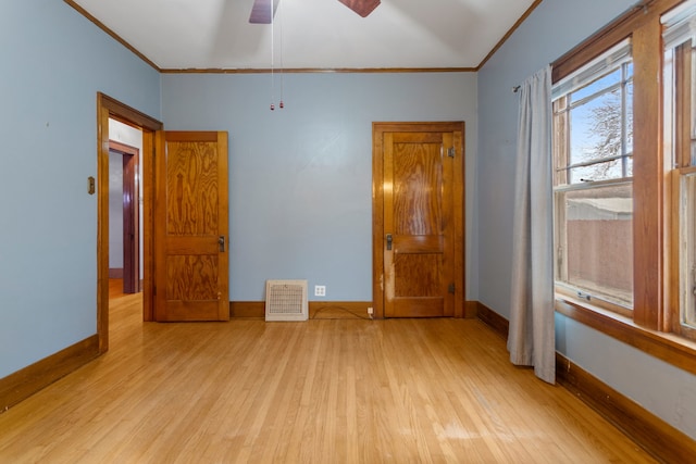 unfurnished bedroom featuring ornamental molding, visible vents, and light wood finished floors