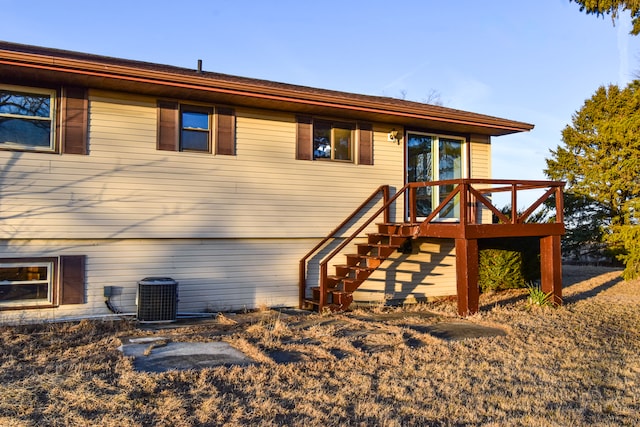 view of front of property featuring cooling unit and stairway