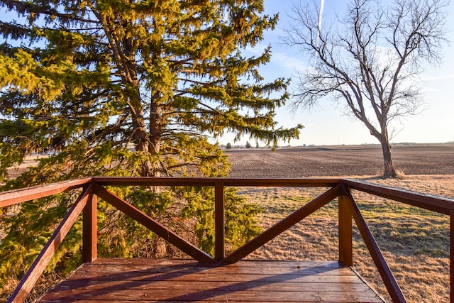 wooden deck with a rural view