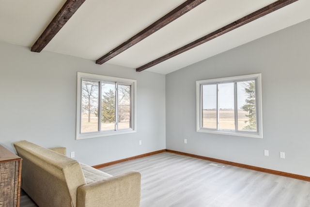 sitting room featuring vaulted ceiling with beams, light wood finished floors, visible vents, and baseboards