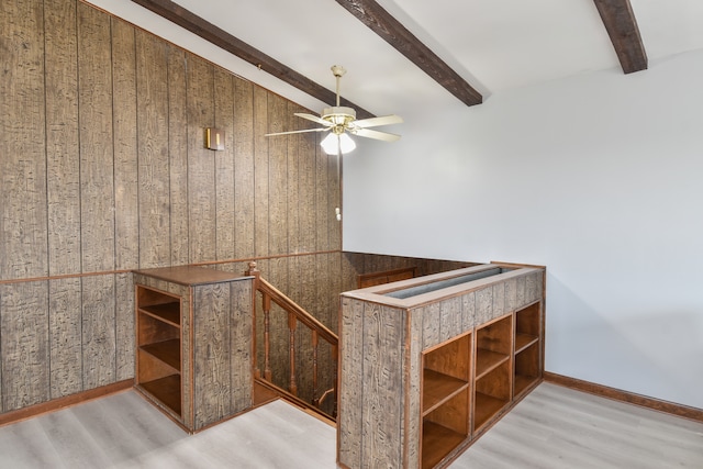 bar with beam ceiling, ceiling fan, baseboards, and wood finished floors