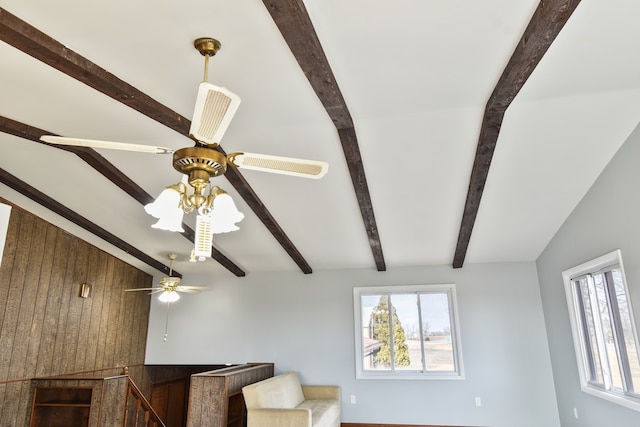 living room with a healthy amount of sunlight, vaulted ceiling with beams, and ceiling fan