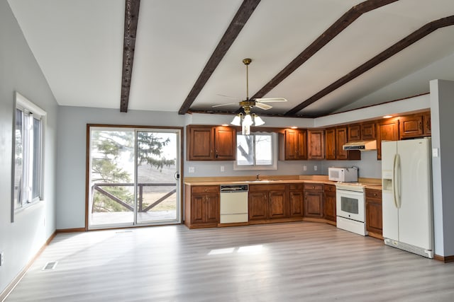 kitchen featuring light wood finished floors, light countertops, white appliances, and visible vents