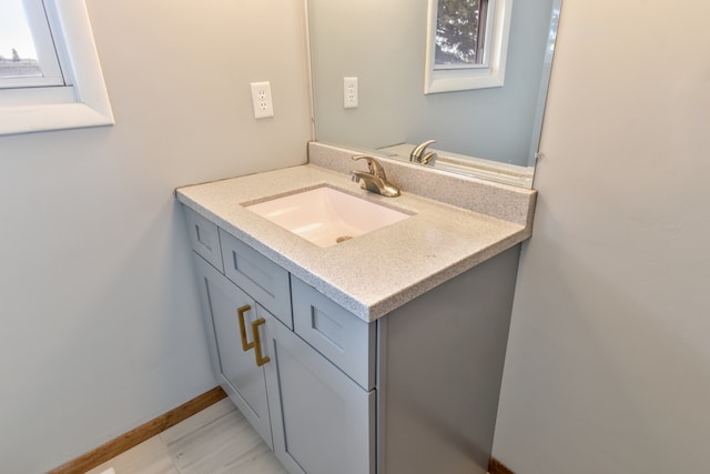 bathroom with baseboards and vanity