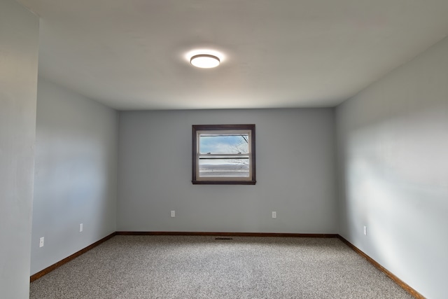 spare room with carpet floors and baseboards