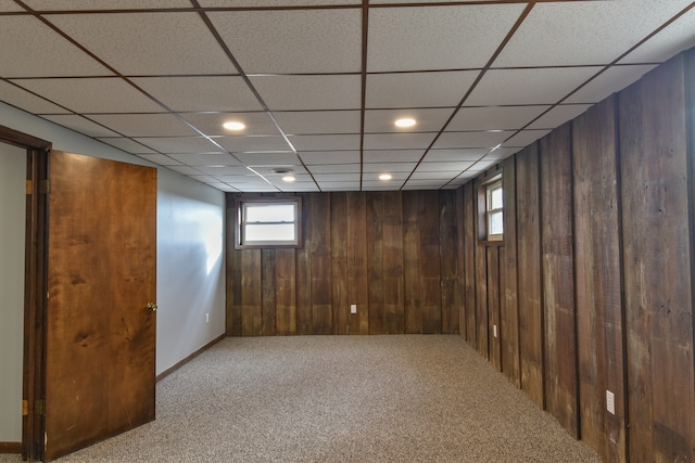 basement with carpet floors, wood walls, and recessed lighting