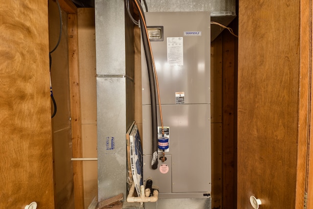 utility room featuring heating unit