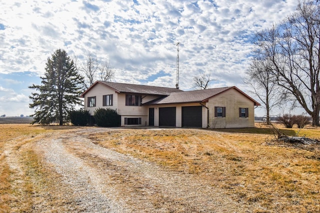 split level home featuring an attached garage and driveway