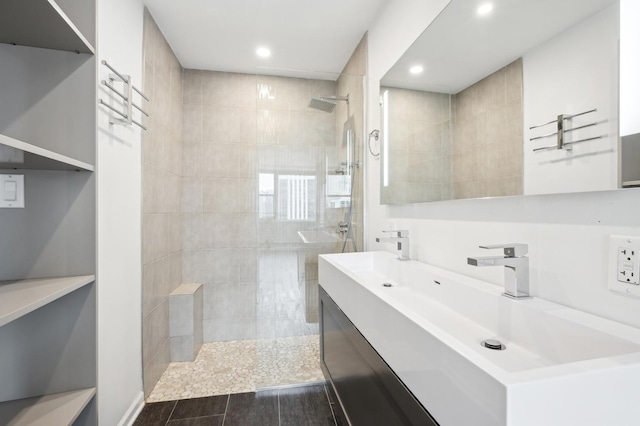 bathroom with vanity and tiled shower