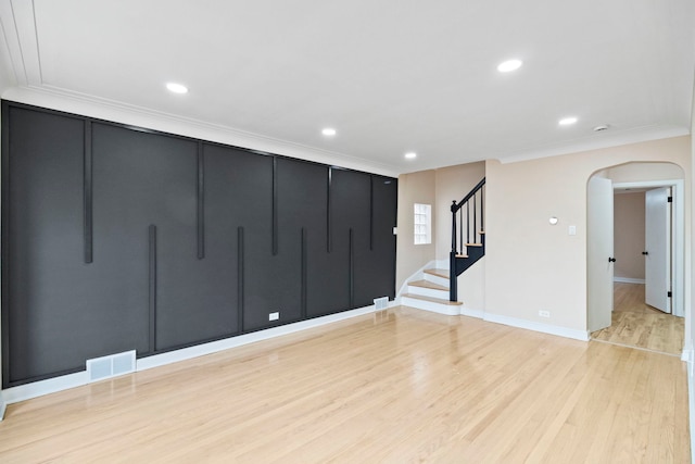 unfurnished room featuring crown molding and light hardwood / wood-style flooring