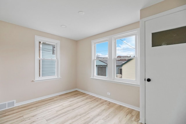 unfurnished room with light hardwood / wood-style flooring