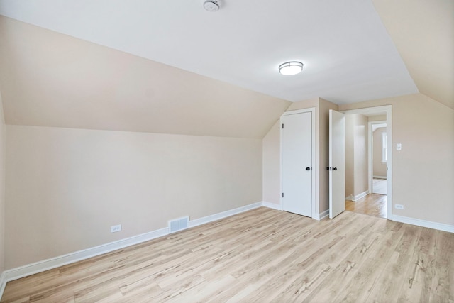 additional living space with lofted ceiling and light hardwood / wood-style floors