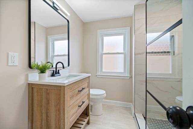 bathroom with vanity, a tile shower, and toilet