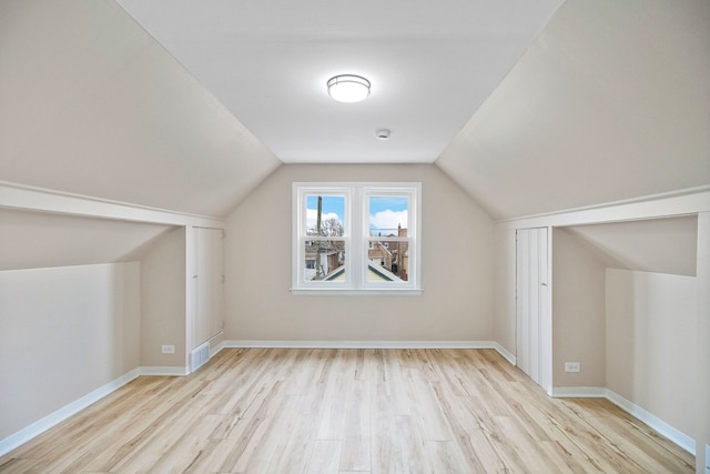 bonus room featuring vaulted ceiling and light hardwood / wood-style floors