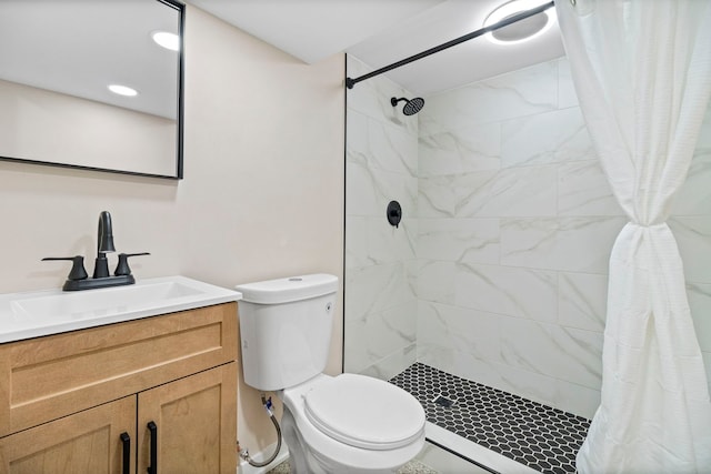 bathroom with walk in shower, vanity, and toilet