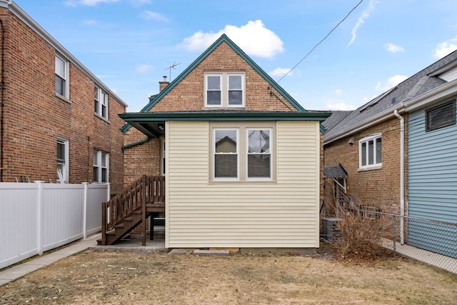 rear view of house featuring cooling unit