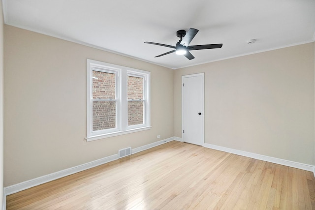 unfurnished room featuring ceiling fan, crown molding, and light wood-type flooring