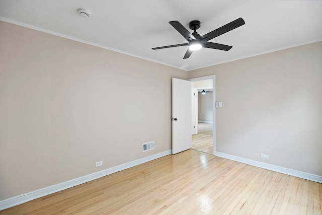 spare room featuring ornamental molding, light hardwood / wood-style floors, and ceiling fan