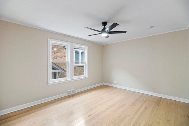 unfurnished room with crown molding, ceiling fan, and light wood-type flooring