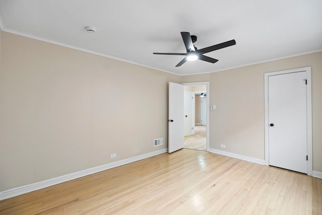 unfurnished bedroom with ornamental molding, ceiling fan, and light wood-type flooring