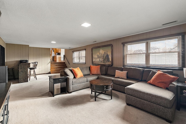 carpeted living room featuring plenty of natural light and a textured ceiling