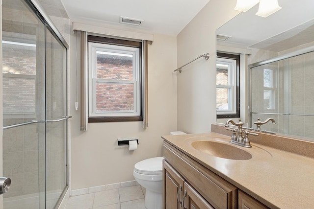 bathroom featuring walk in shower, tile patterned floors, toilet, and vanity