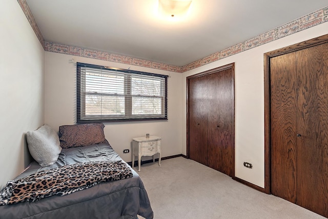 carpeted bedroom with multiple closets