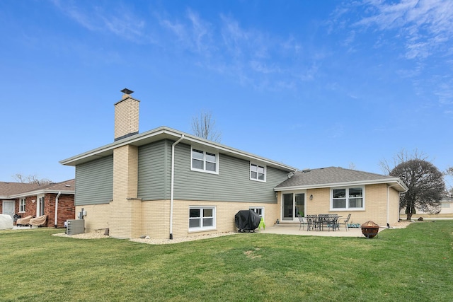 back of house featuring central AC, a yard, and a patio area