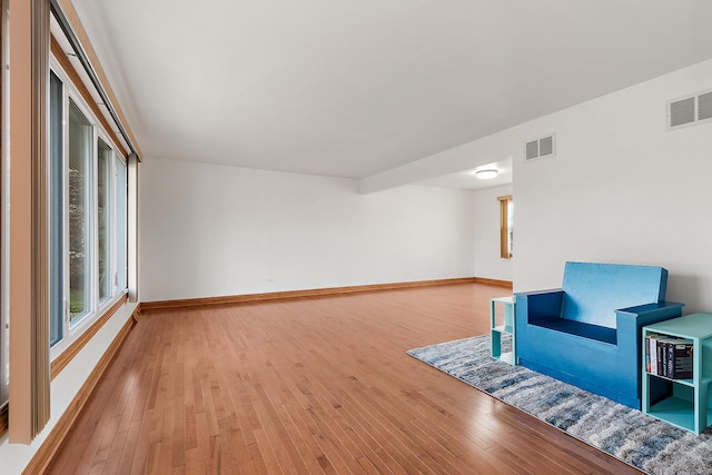 unfurnished room featuring a wealth of natural light and light wood-type flooring