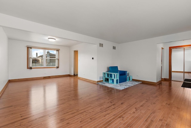 unfurnished living room featuring wood-type flooring