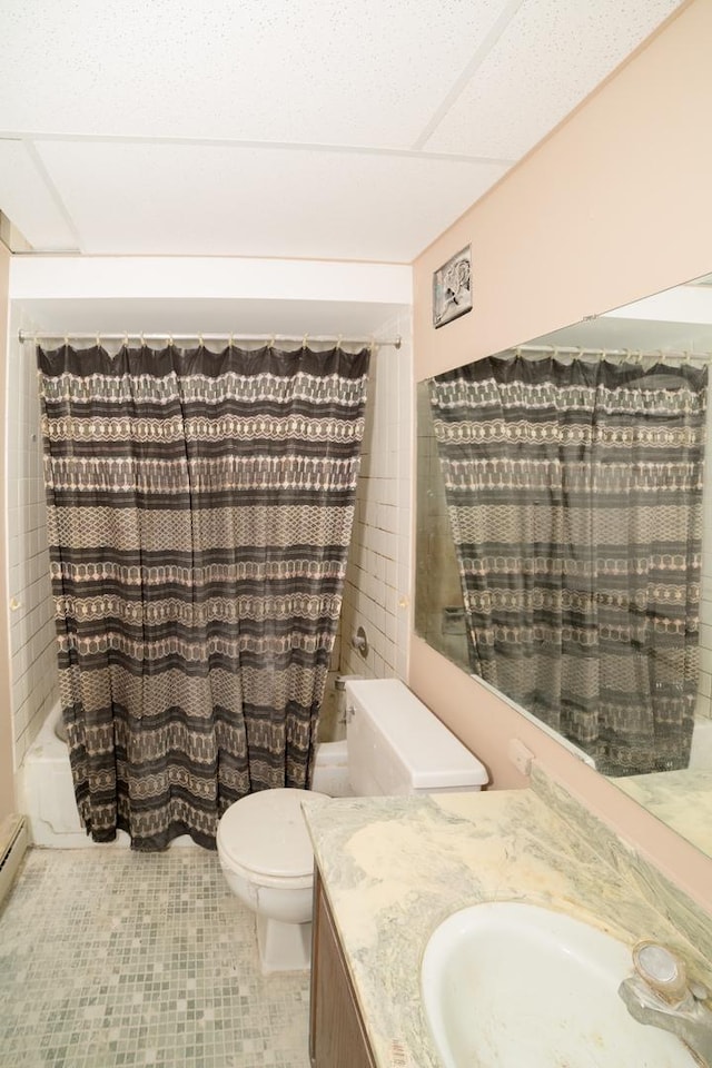 full bathroom with vanity, toilet, shower / tub combo, and a drop ceiling