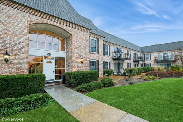 property entrance with a lawn