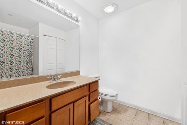 bathroom featuring vanity, tile patterned floors, and toilet