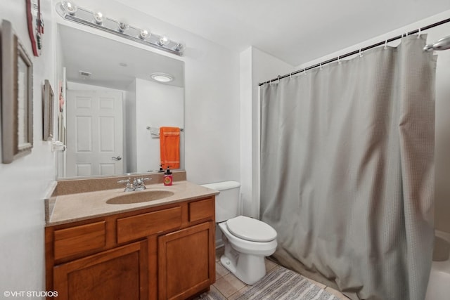 full bathroom with tile patterned floors, vanity, toilet, and shower / bath combo with shower curtain