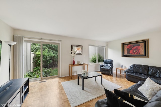 living room featuring a healthy amount of sunlight and light parquet floors