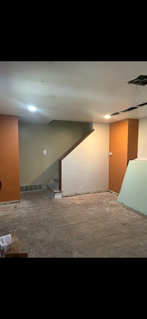 finished below grade area with visible vents and stairway
