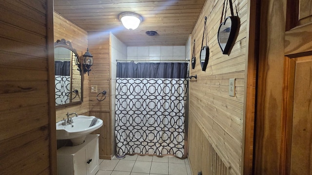 bathroom with tile patterned flooring, sink, curtained shower, and wooden ceiling