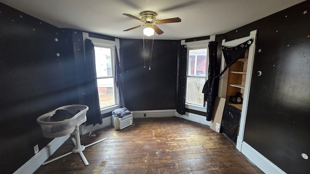 interior space with dark hardwood / wood-style flooring and a healthy amount of sunlight