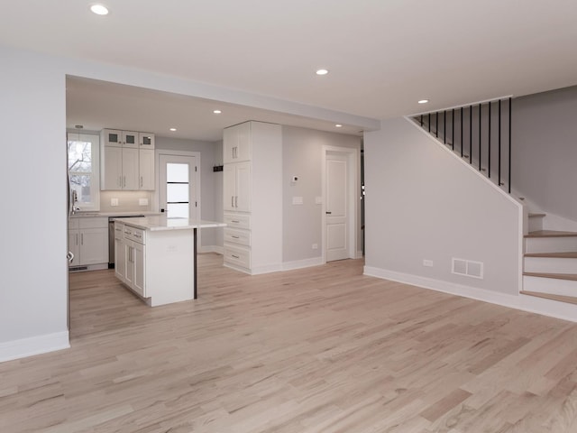 6310 Hilly Way, Cary, IL 60013 - kitchen with light wood-style floors, white cabinets, recessed lighting, a center island, and open floor plan