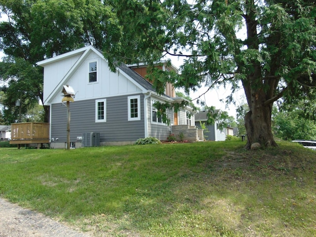 6310 Hilly Way, Cary, IL 60013 - view of home's exterior featuring board and batten siding, a wooden deck, and a lawn