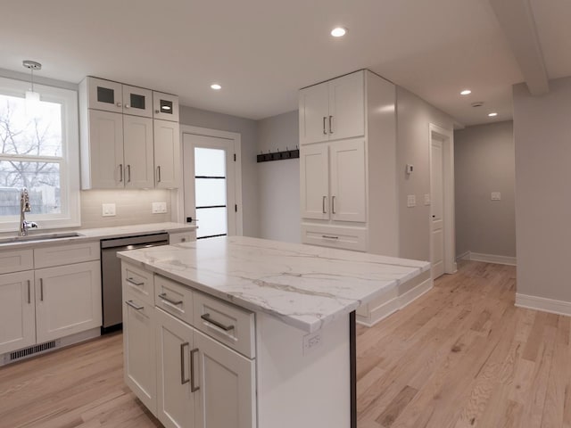 6310 Hilly Way, Cary, IL 60013 - kitchen with stainless steel dishwasher, recessed lighting, white cabinetry, light wood-style flooring, and light stone countertops