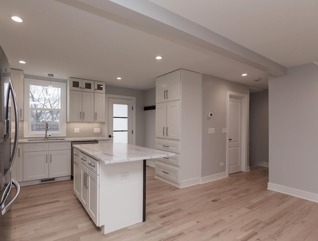 6310 Hilly Way, Cary, IL 60013 - kitchen featuring light stone countertops, recessed lighting, light wood finished floors, a kitchen island, and plenty of natural light